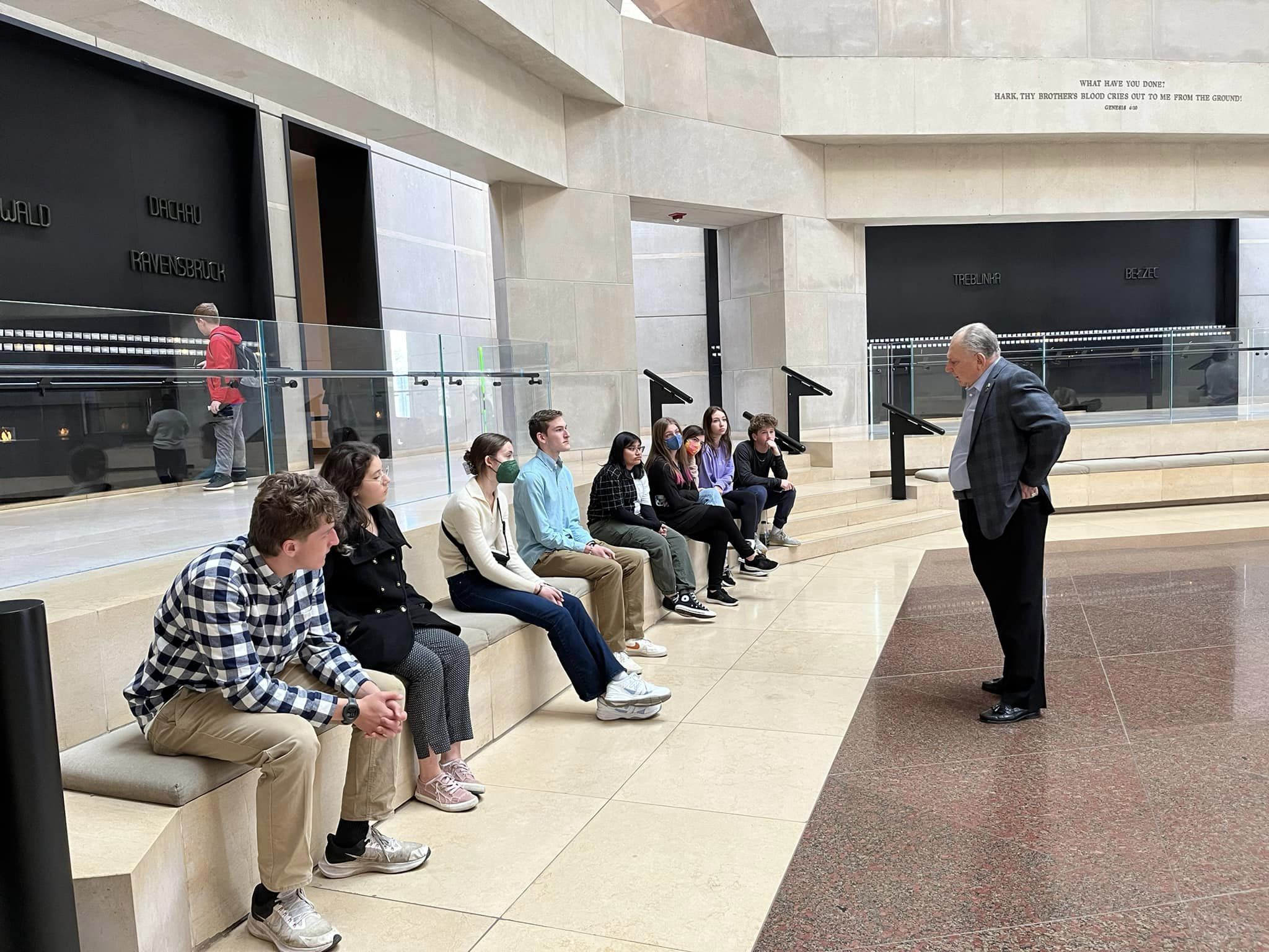 Sam Devinki speaks to students on the Together We Remember trip.